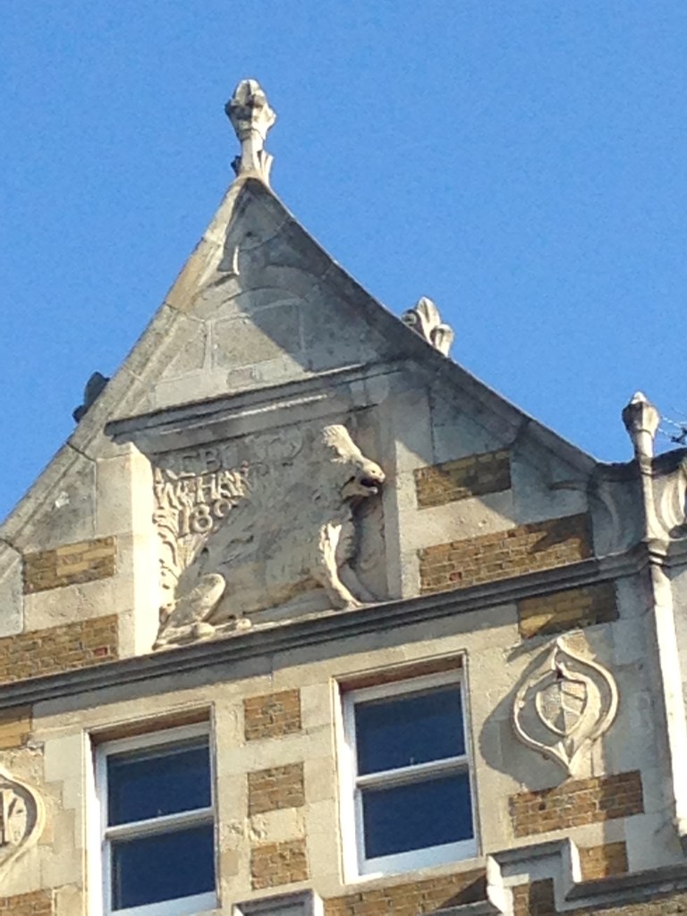 A boar insignia above a shop